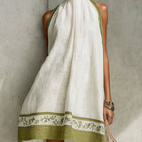 Agathe | Mini Trapeze Dress in White and Olive Green Floral Print